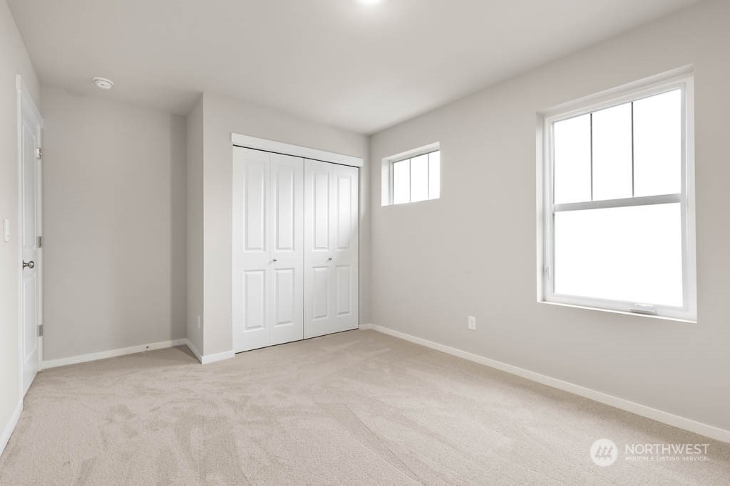 18937 Liberty Rdg Lane, Unit 955 Puyallup, WA 98374 - Photo 18 of 19 an empty room with windows