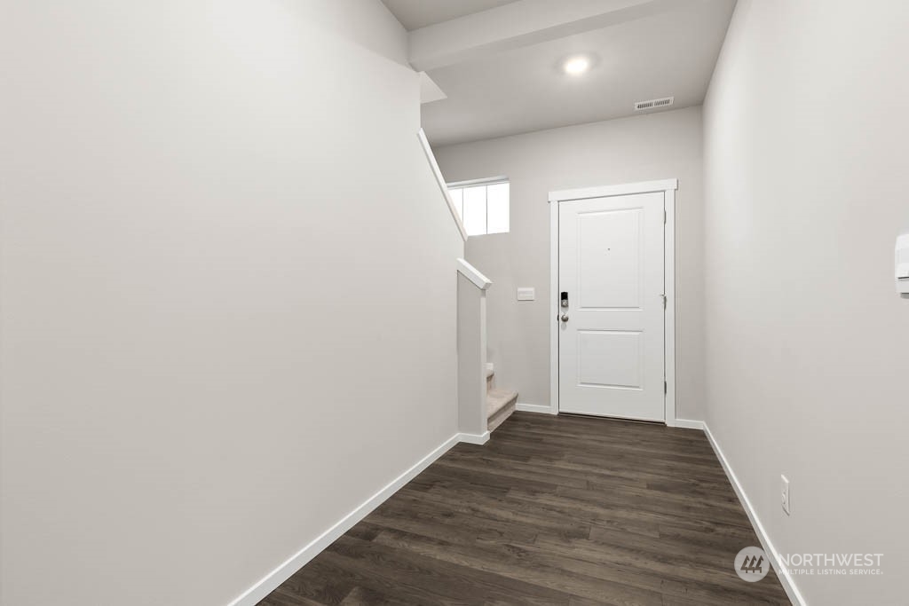 18937 Liberty Rdg Lane, Unit 955 Puyallup, WA 98374 - Photo 2 of 19 a view of a hallway with wooden floor
