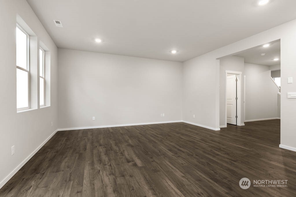 18937 Liberty Rdg Lane, Unit 955 Puyallup, WA 98374 - Photo 3 of 19 a view of an empty room with wooden floor and a window