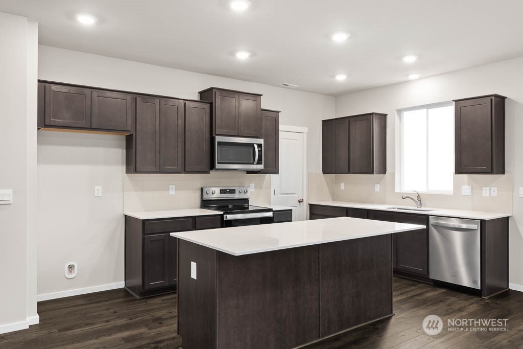 18937 Liberty Rdg Lane, Unit 955 Puyallup, WA 98374 - Photo 6 of 19 a kitchen with a sink stove top oven and refrigerator