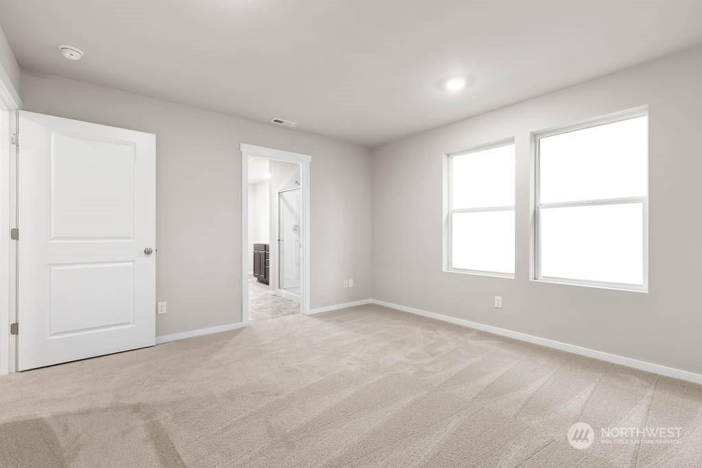 18937 Liberty Rdg Lane, Unit 955 Puyallup, WA 98374 - Photo 8 of 19 an empty room with windows and closet