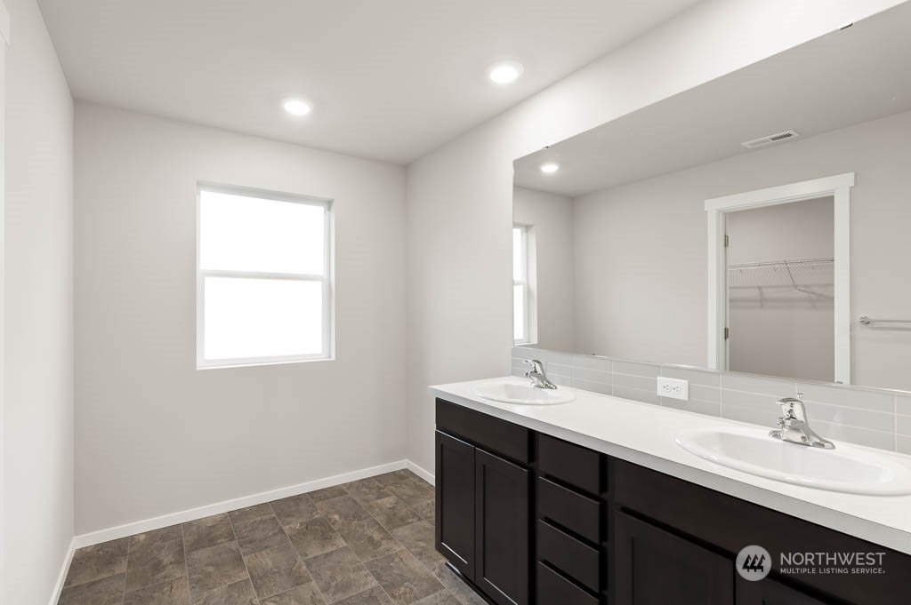 18937 Liberty Rdg Lane, Unit 955 Puyallup, WA 98374 - Photo 9 of 19 a bathroom with a double vanity sink and a mirror
