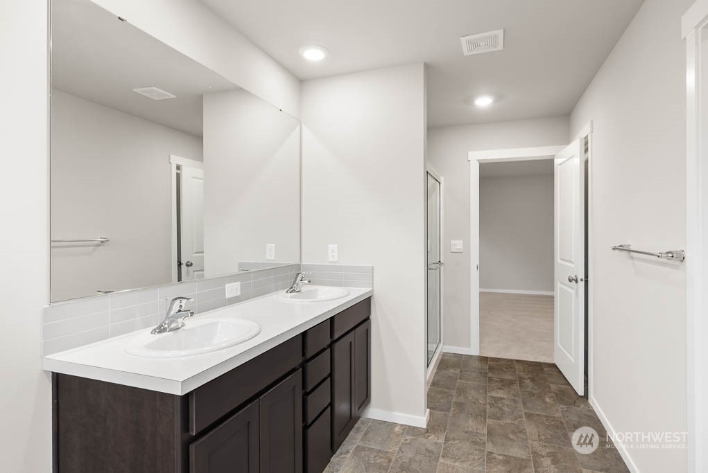 18937 Liberty Rdg Lane, Unit 955 Puyallup, WA 98374 - Photo 10 of 19 a bathroom with a sink double vanity and a mirror