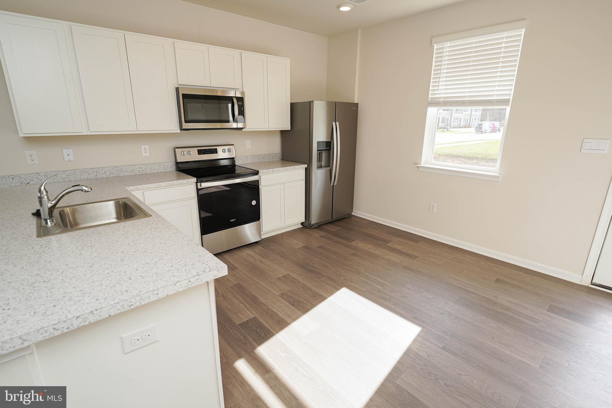 826 Derwent Lane Salisbury, MD 21801 - Photo 12 of 45 a kitchen with a refrigerator stove and microwave