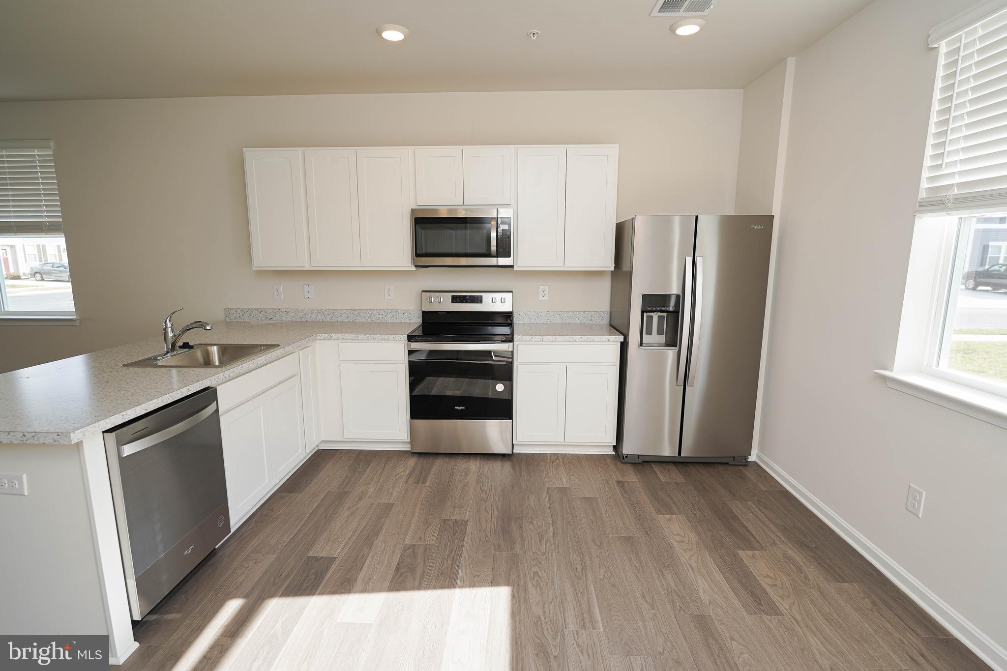 826 Derwent Lane Salisbury, MD 21801 - Photo 13 of 45 a kitchen with wooden floors and appliances