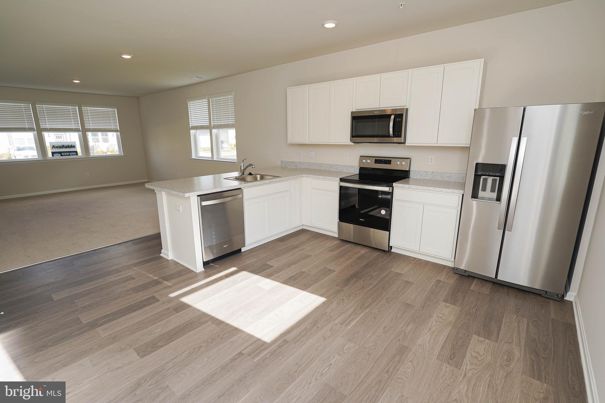 826 Derwent Lane Salisbury, MD 21801 - Photo 14 of 45 a kitchen with granite countertop a refrigerator stove and sink