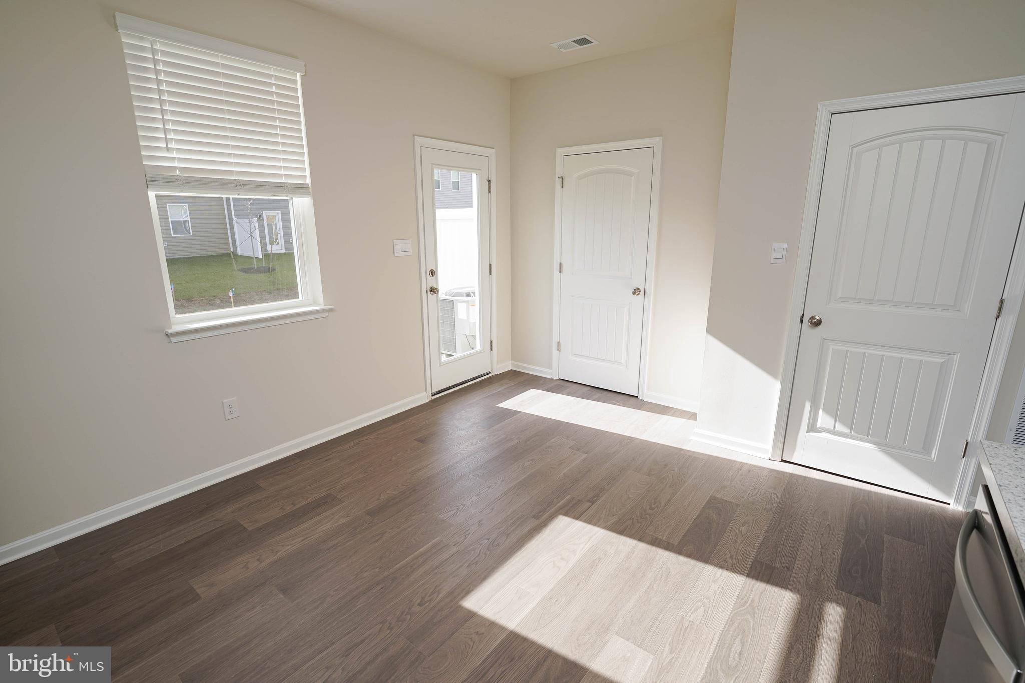 826 Derwent Lane Salisbury, MD 21801 - Photo 16 of 45 an empty room with wooden floor and windows