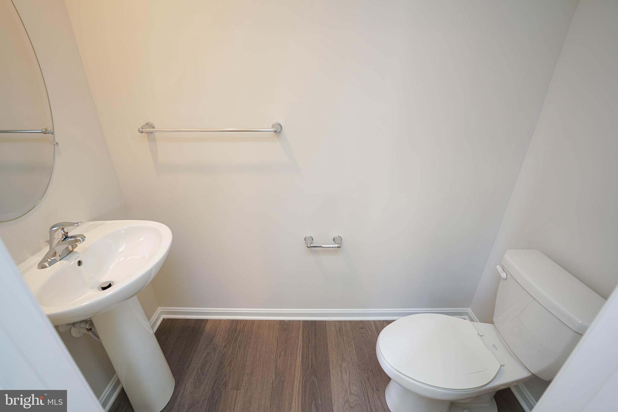 826 Derwent Lane Salisbury, MD 21801 - Photo 19 of 45 a bathroom with a sink a toilet and a mirror