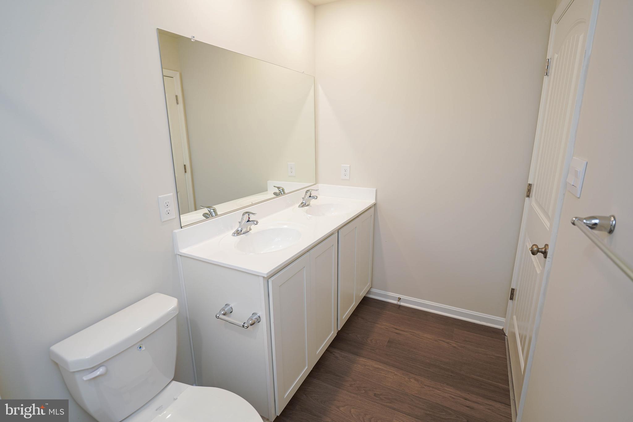 826 Derwent Lane Salisbury, MD 21801 - Photo 31 of 45 a bathroom with a sink a toilet and a mirror