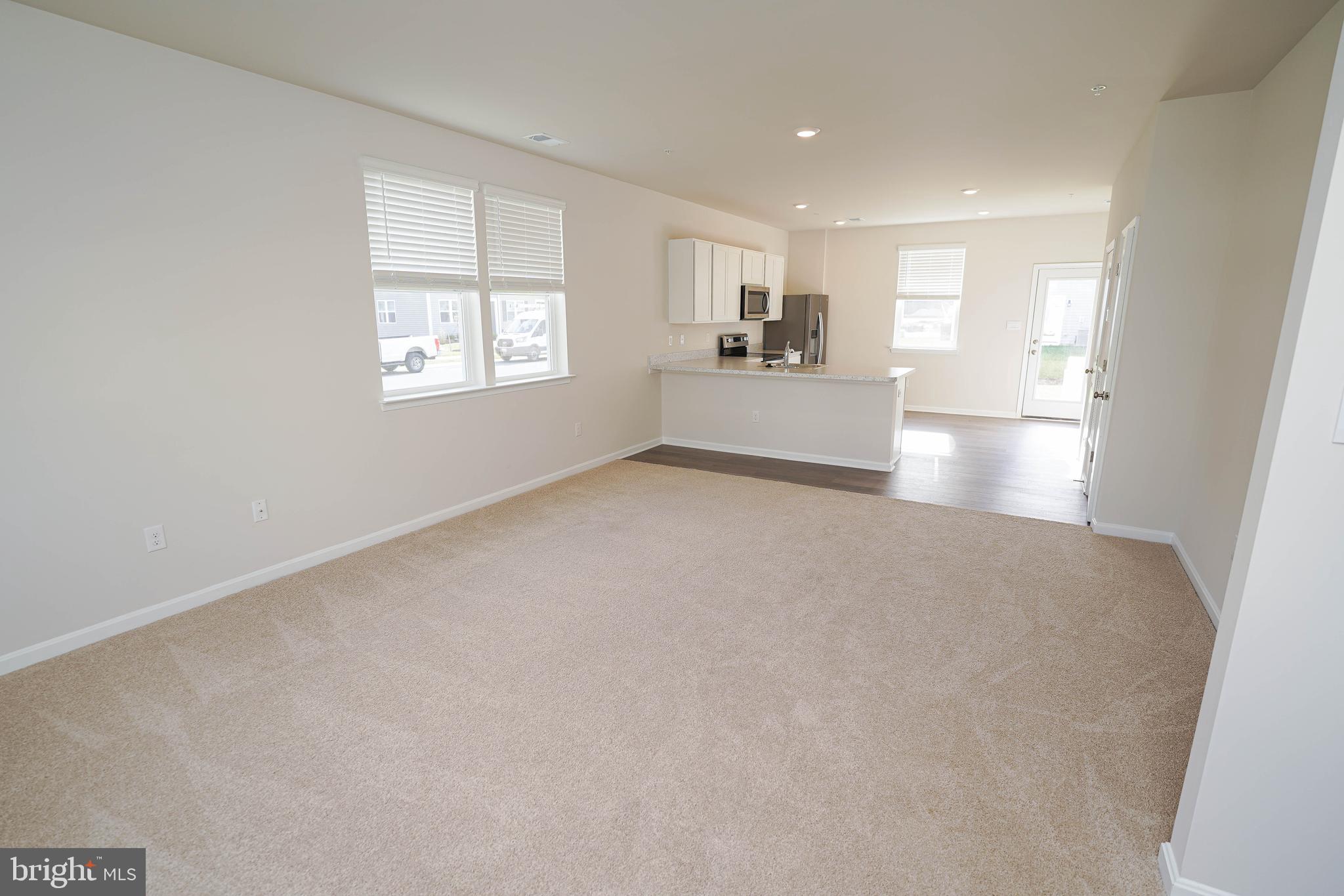 826 Derwent Lane Salisbury, MD 21801 - Photo 8 of 45 a view of empty room with wooden floor and windows