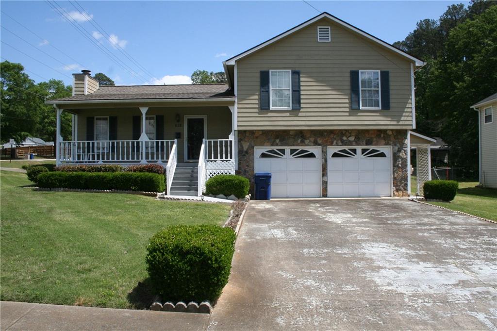 101 Ashford Drive Dallas, GA 30132 - Photo 1 of 1 a front view of a house with a yard and potted plants