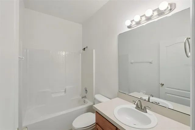 a bathroom with a sink toilet a shower and a mirror
