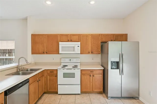 a kitchen with a sink stove and refrigerator