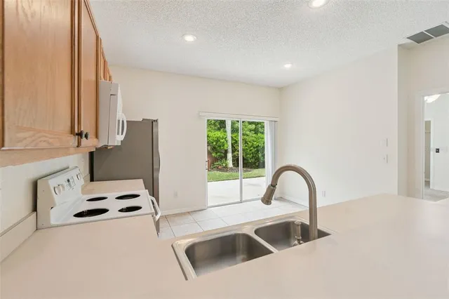 a kitchen with a stove a sink and a refrigerator