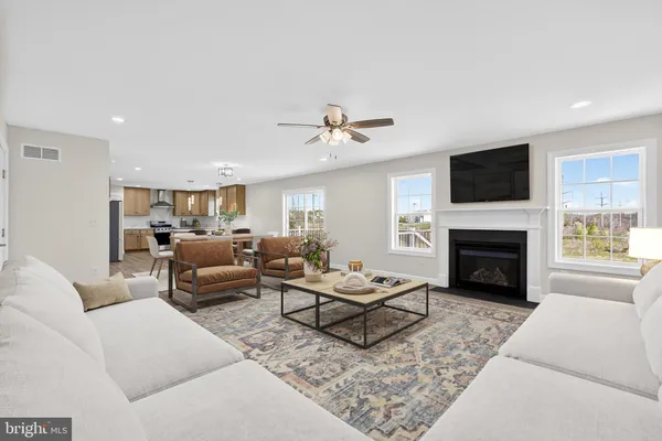 a living room with furniture and a fireplace