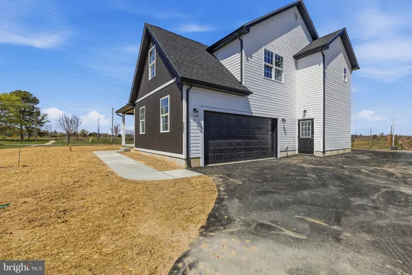 a view of a house with a yard and garage