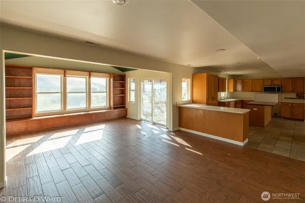 a view of a kitchen with a sink and a large window