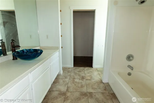 a bathroom with a bathtub and a sink