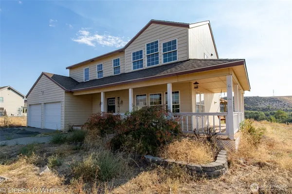 a front view of house with yard and outdoor seating