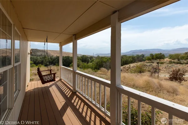 a view of a balcony with lake view and wooden floor