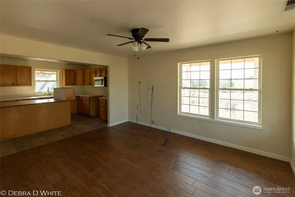 a view of a kitchen with a sink dishwasher cabinets and a window