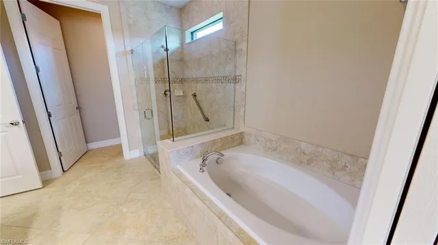 a bathroom with a granite countertop sink a toilet a mirror and shower