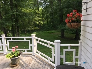 3674 Congress Street Fairfield, CT 06824 - Photo 33 of 33 Summer early evening photo of the rear yard showing the large and gorgeous Ipe deck
