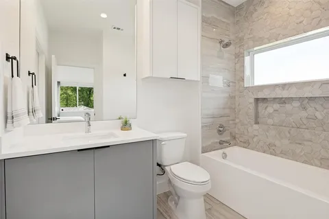 a bathroom with a sink a toilet and bathtub