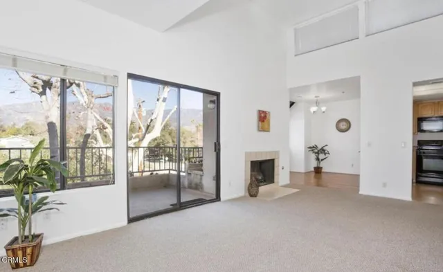 a view of empty room with floor to ceiling window and an outdoor view