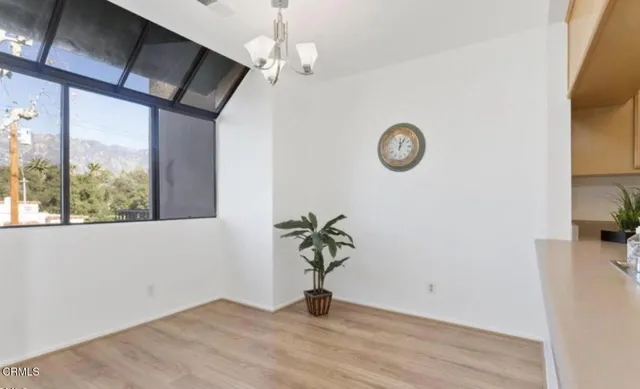a view of a room with wooden floor and window