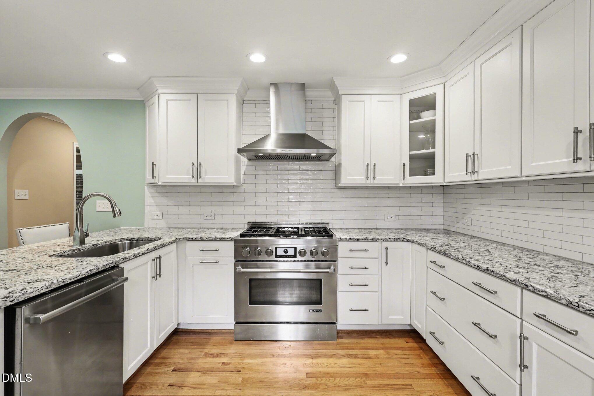 1212 Kershaw Drive Raleigh, NC 27609 - Photo 4 of 42 Quartz counters, Stainless Steel appliances, subway tile backsplash & gas range.