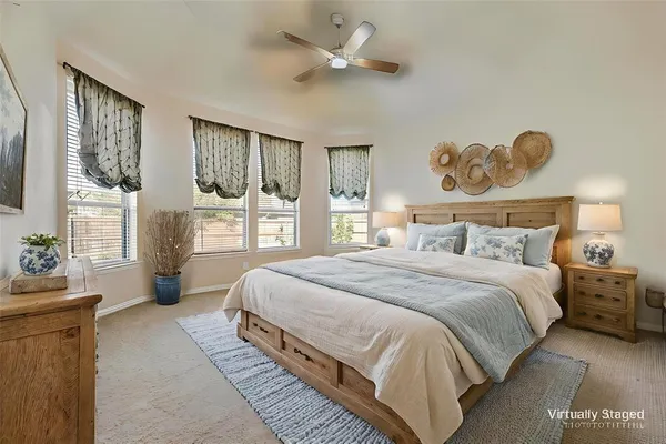 a bedroom with a bed and dresser with mirror