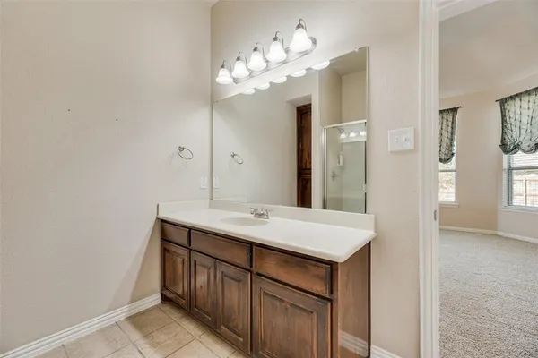 a bathroom with a sink a light fixture and a mirror