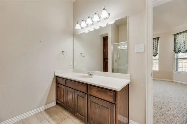 a bathroom with a sink a light fixture and a mirror