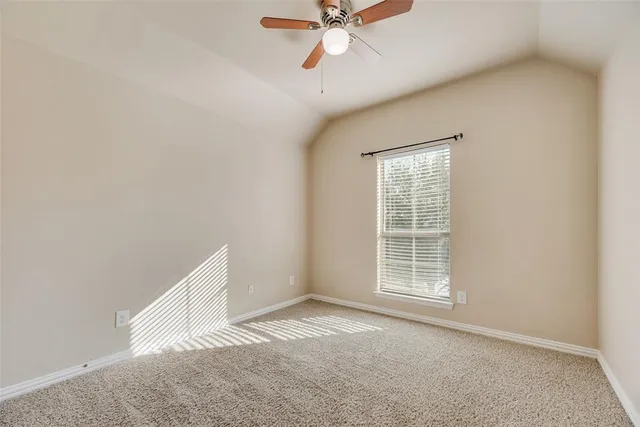 an empty room with closet and fan
