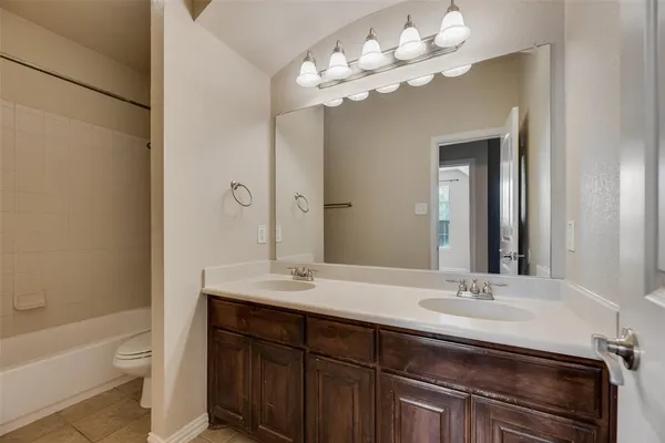 a bathroom with a sink a toilet and a bathtub
