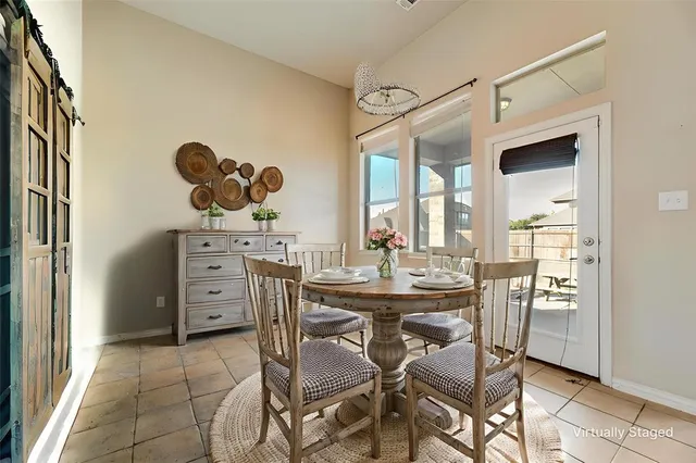 a dining room with furniture and window