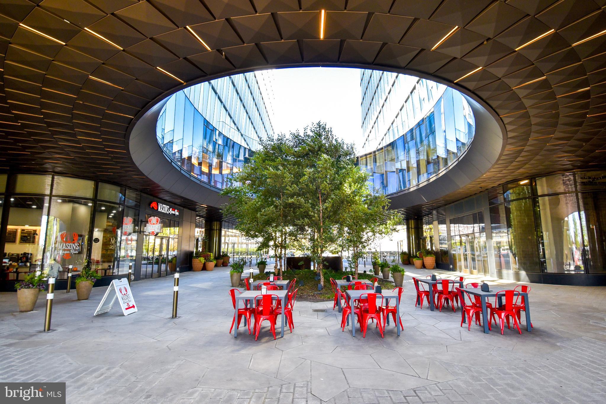 700 7th Street Southwest, Unit 826 Washington, DC 20024 - Photo 36 of 49 Modern plaza with vibrant red seating.
