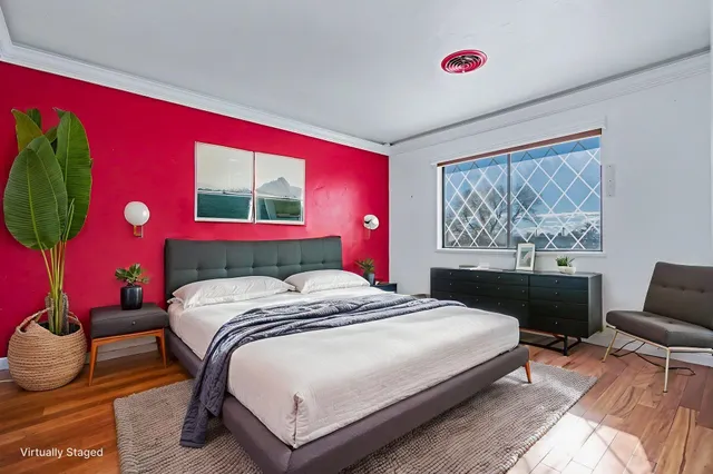 a bedroom with a bed and a lamp