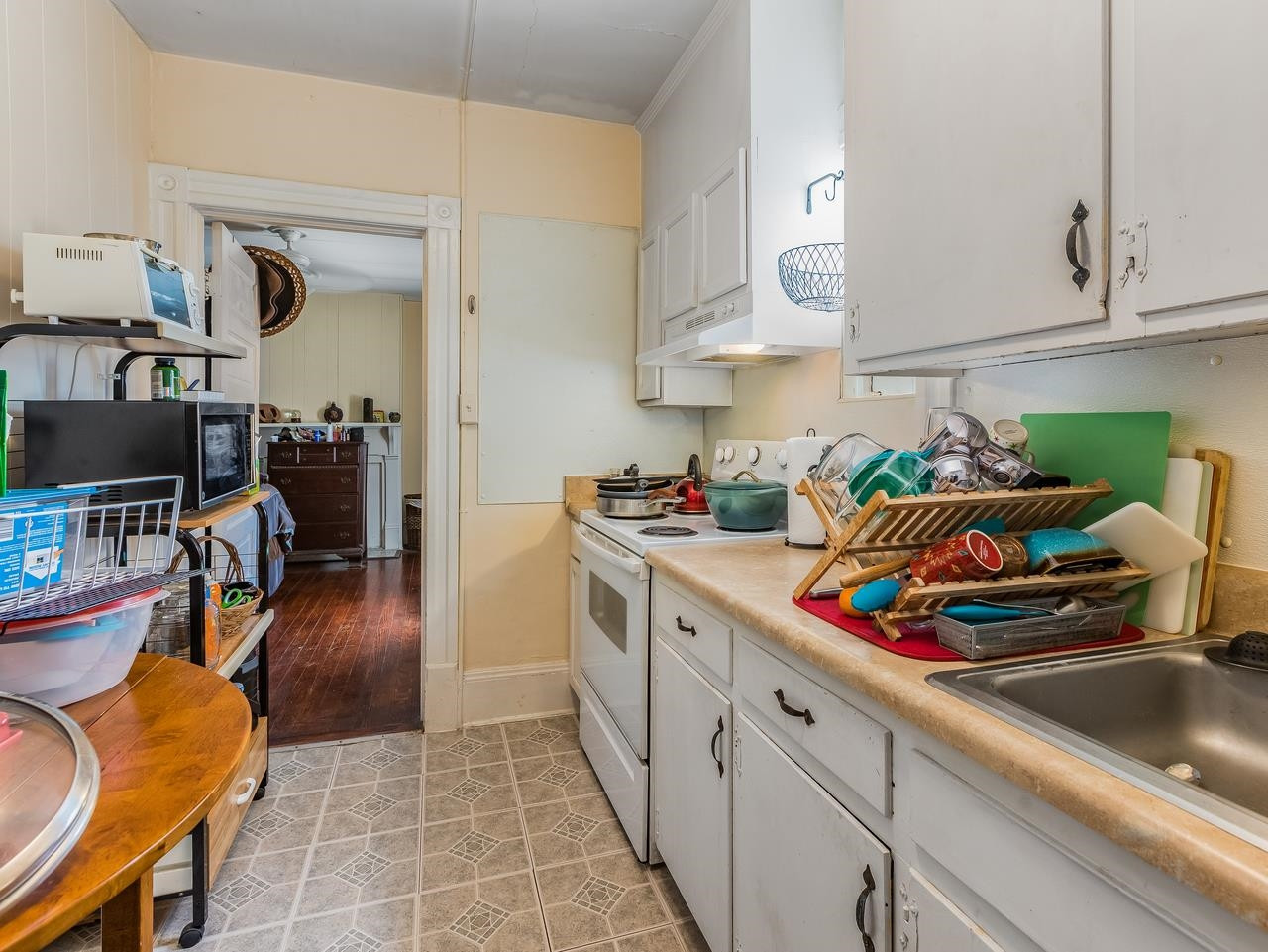 508 Tilden Street, Unit 1 Raleigh, NC 27605 - Photo 7 of 16 a kitchen with stainless steel appliances granite countertop a sink a stove and a wooden floors