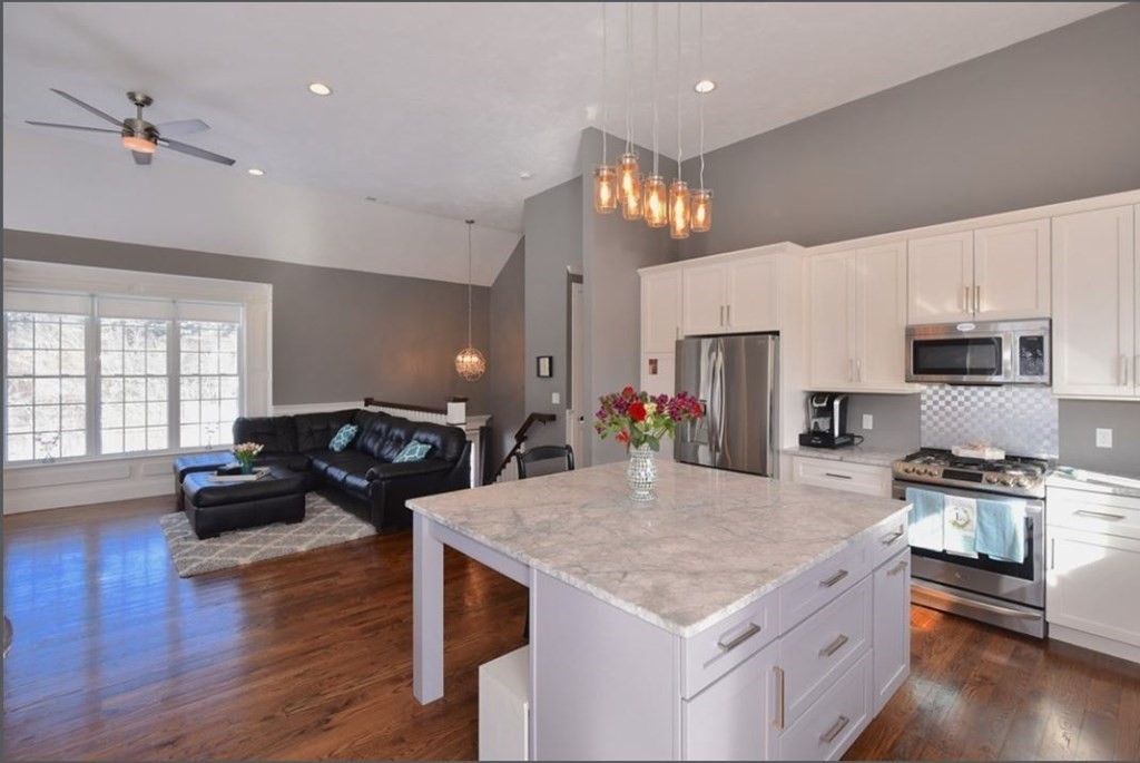 a kitchen with granite countertop a stove and a refrigerator