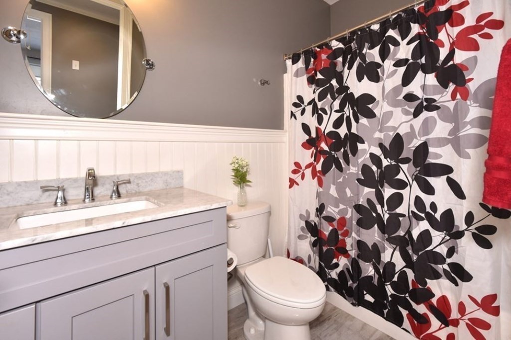 261 Main Street, Unit 1 Shrewsbury, MA 01545 - Photo 11 of 14 a bathroom with a sink and a mirror
