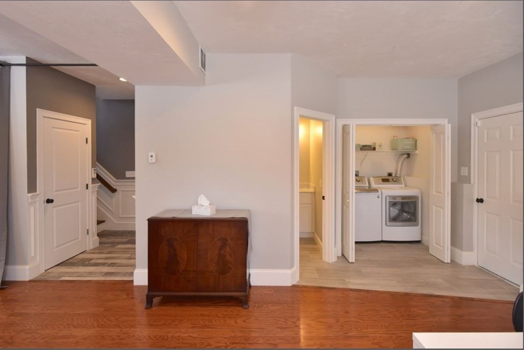 261 Main Street, Unit 1 Shrewsbury, MA 01545 - Photo 13 of 14 a view of a hallway with wooden floor and living room