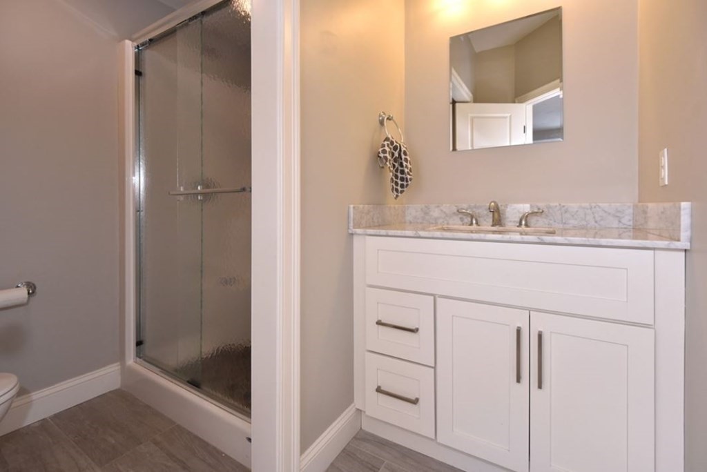 261 Main Street, Unit 1 Shrewsbury, MA 01545 - Photo 14 of 14 a bathroom with a sink and a mirror