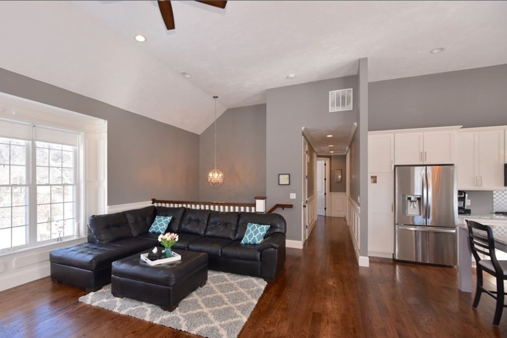 261 Main Street, Unit 1 Shrewsbury, MA 01545 - Photo 2 of 14 a living room with furniture and a wooden floor