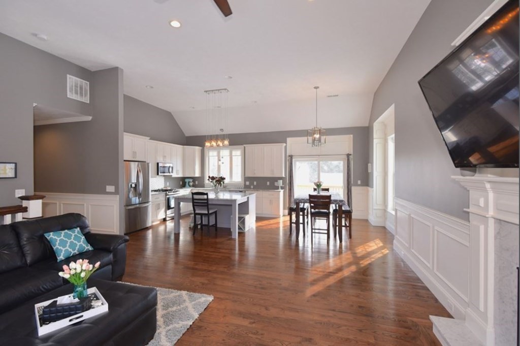 261 Main Street, Unit 1 Shrewsbury, MA 01545 - Photo 3 of 14 a living room with furniture wooden floor and a flat screen tv