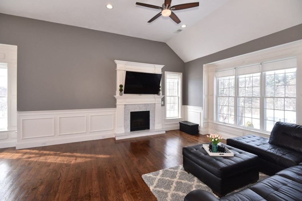261 Main Street, Unit 1 Shrewsbury, MA 01545 - Photo 4 of 14 a living room with furniture a fireplace and a flat screen tv
