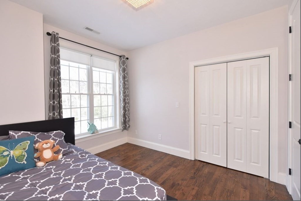 261 Main Street, Unit 1 Shrewsbury, MA 01545 - Photo 9 of 14 a bedroom with a bed and a window