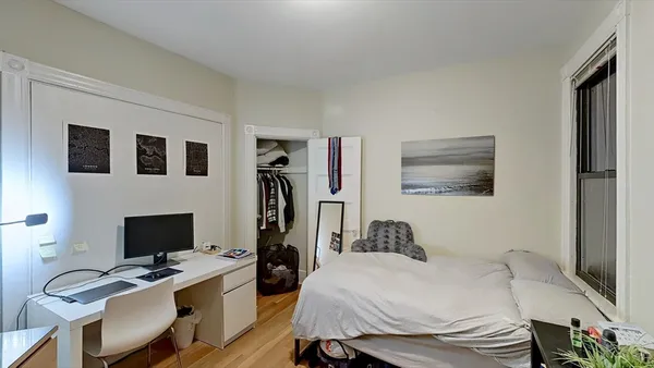 a bedroom with a bed and a desk