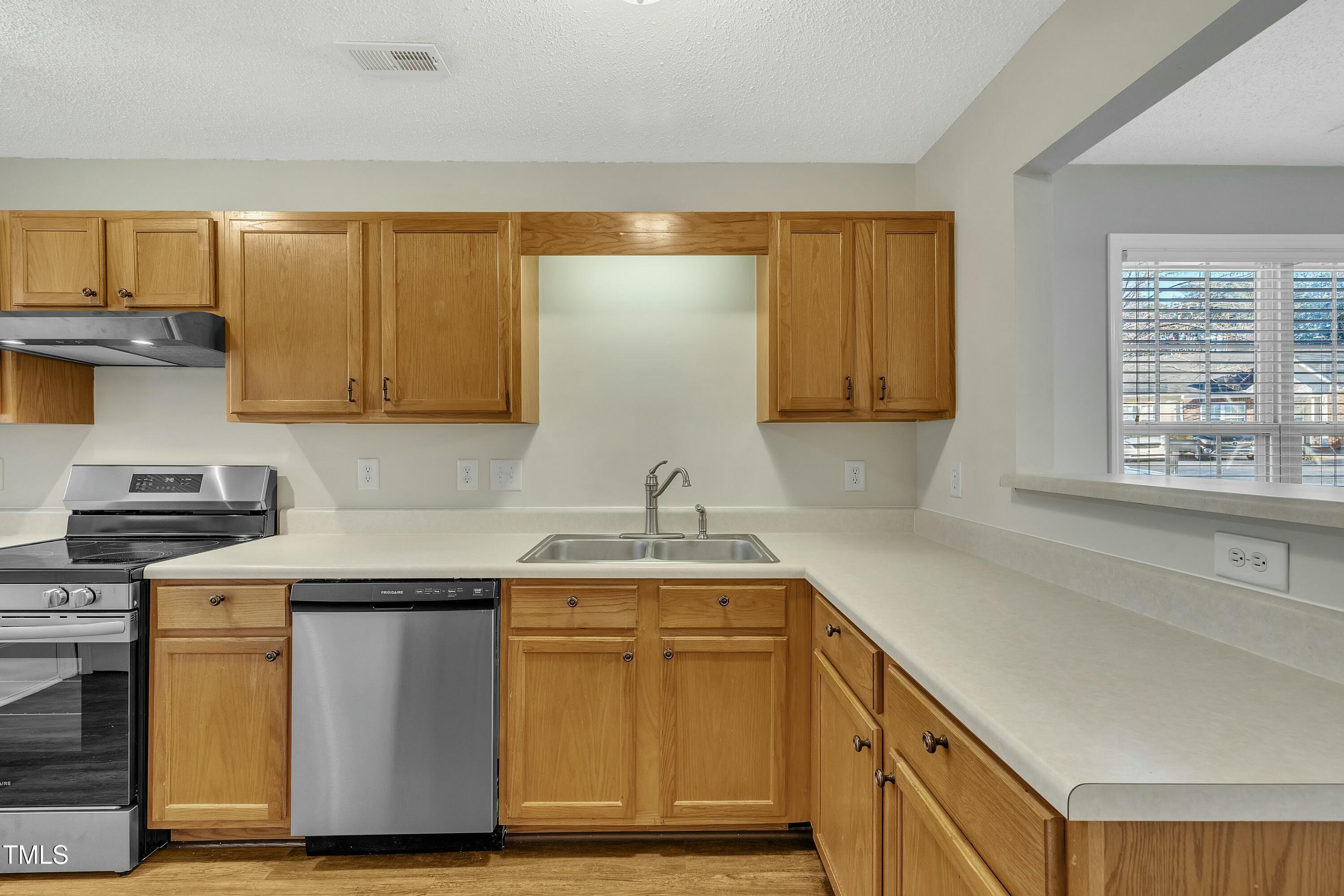 3727 Votive Lane Raleigh, NC 27604 - Photo 12 of 28 Kitchen at back of home, the window look thru looks into dining and family/living room.